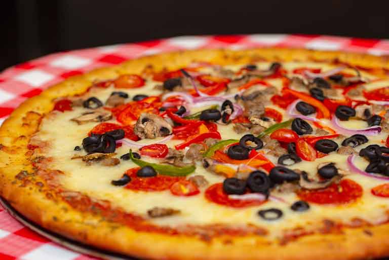 A supreme pizza made fresh at Safari Pizza Company at ZooTampa