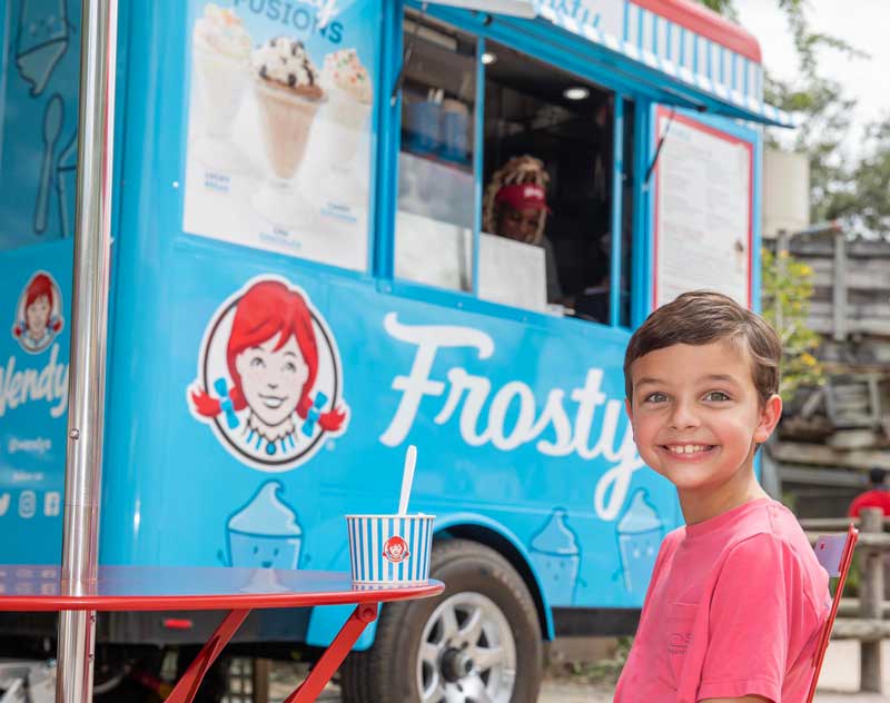 A child smiles as he get a Frosty from the Wendys Frosty Cart at ZooTampa